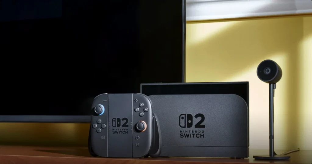 Nintendo Switch 2 en su base junto a un televisor y la cámara de la consola